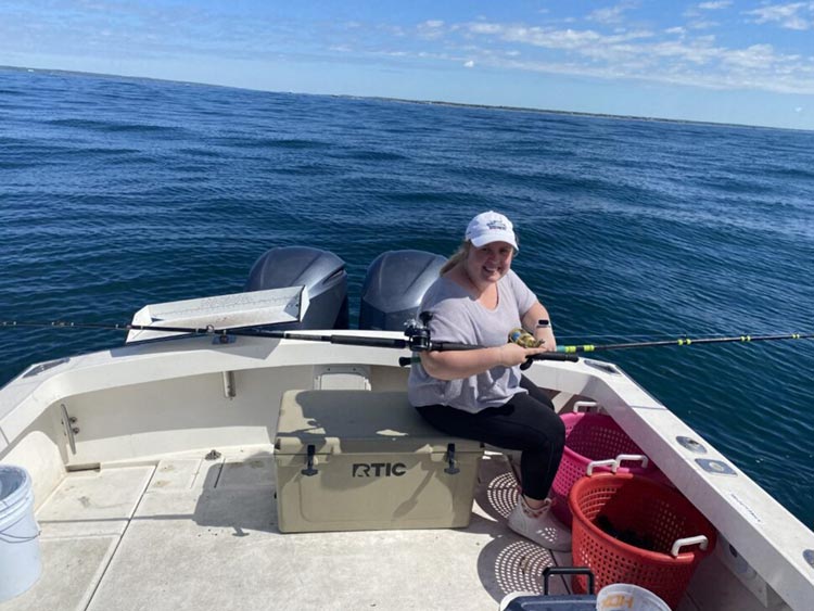 Woman on boat with fishing rods