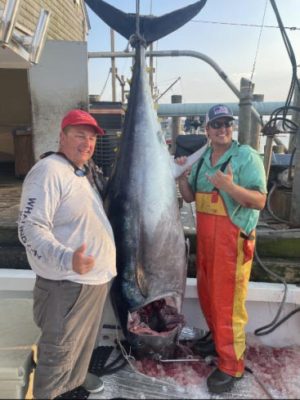 Two fisherman with a large fish