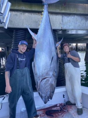 2 fishermen posing with a caught fish